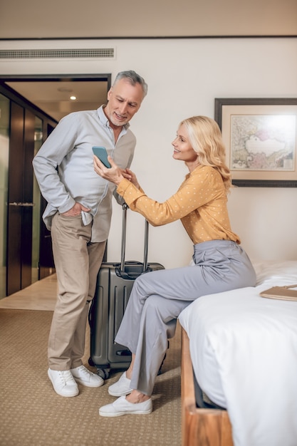 Couple in a hotel. Mid-aged couple in a hotel room looking contented