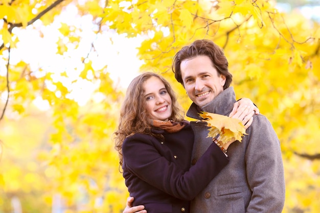 Couple hug in autumn forest