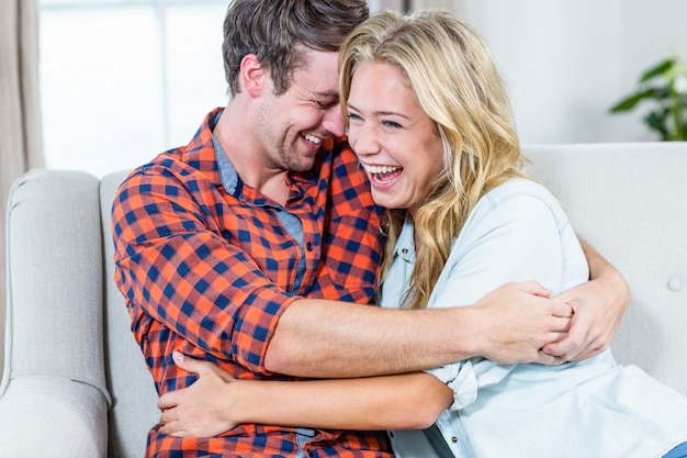 Couple hugging on the couch in the living room