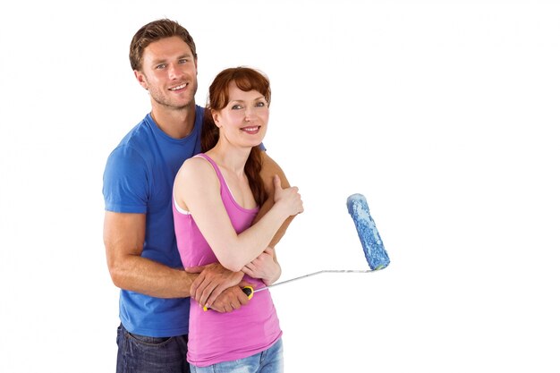 Couple hugging and holding brush