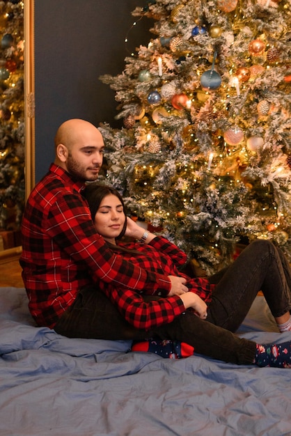 Couple hugging at home  in Christmas decorations