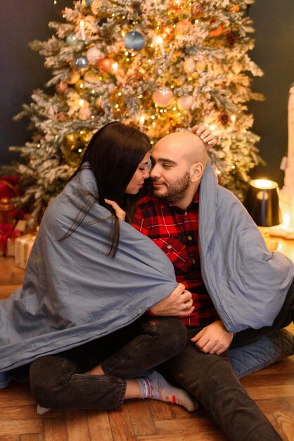 Couple hugging at home  in Christmas decorations