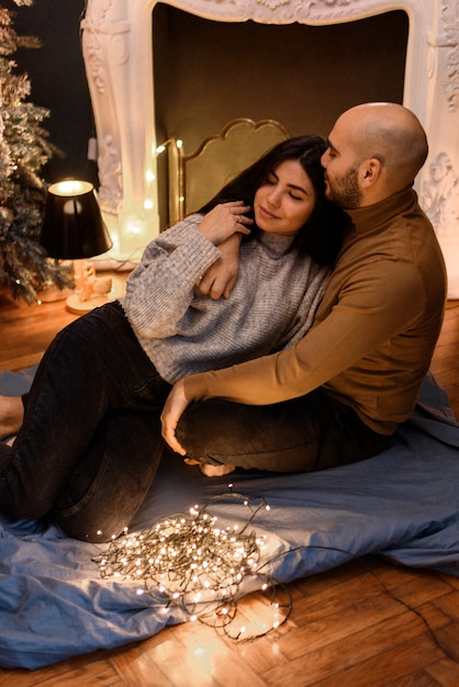 Couple hugging at home  in Christmas decorations