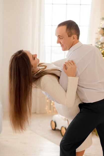 Couple hugging at home  in Christmas decorations