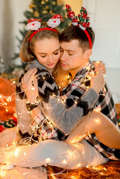 Couple hugging at home  in Christmas decorations