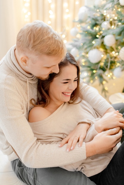 Couple hugging at home  on the eve of Christmas