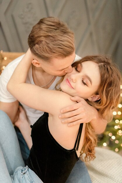 Couple hugging at home on the eve of Christmas