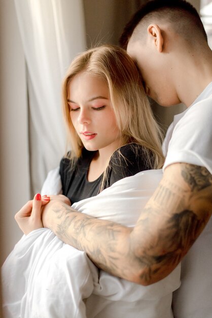 Couple hugging at home