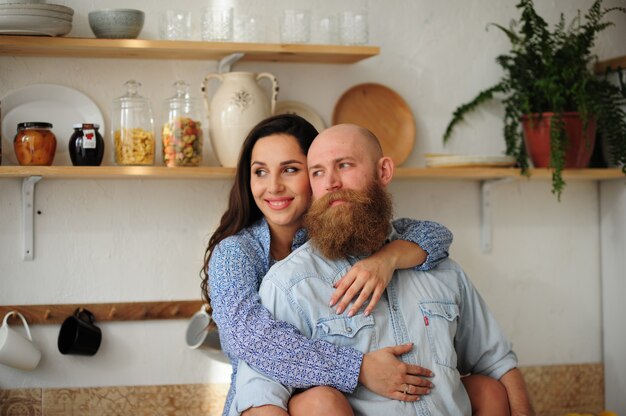 Couple hugging in the kitchen.