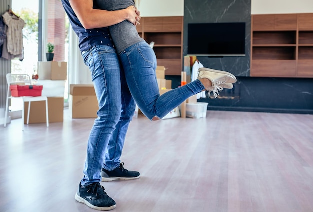 Couple hugging in the living room of their new house