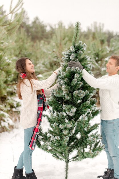 Couple hugging in snowy forest