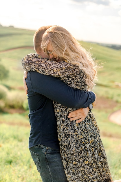 Couple hugging in the summer field