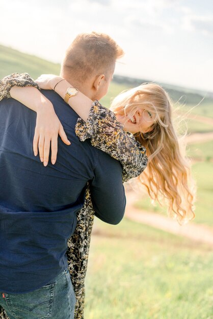 Couple hugging in the summer field