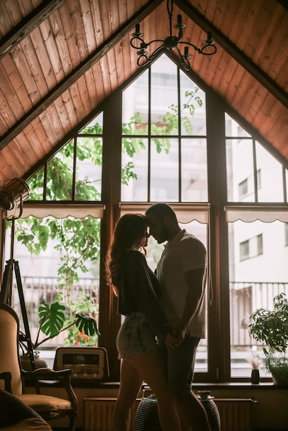 Couple hugging in wooden house