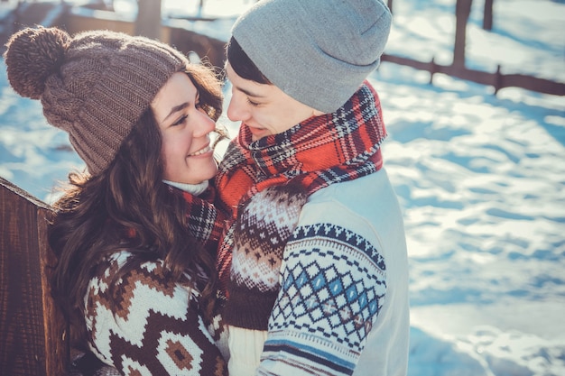 Couple hugs in winter park