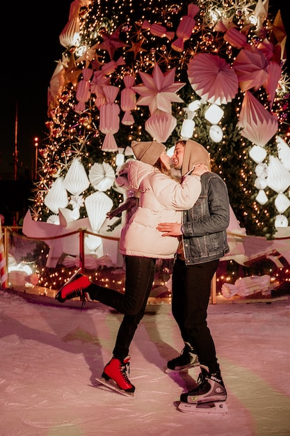 Couple at ice skating rink kissing