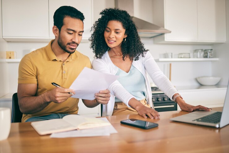 Photo couple insurance paperwork and budget planning with laptop bills and finance with taxes and mortgage financial documents payment and loan with policy audit and review with asset management