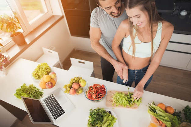 A Couple Is Preparing A Salad For A Breakfast.