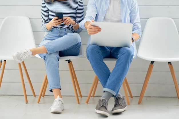 Couple is using a laptop and smartphone