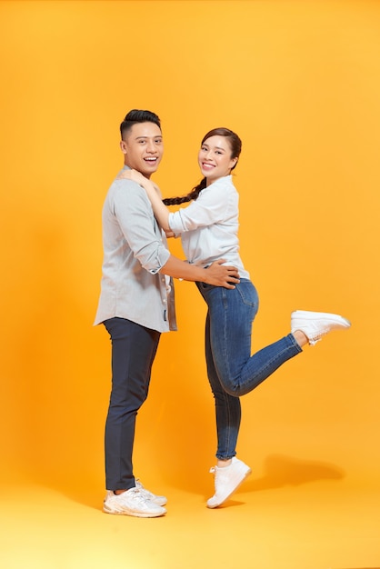 A couple isolated over a yellow color background