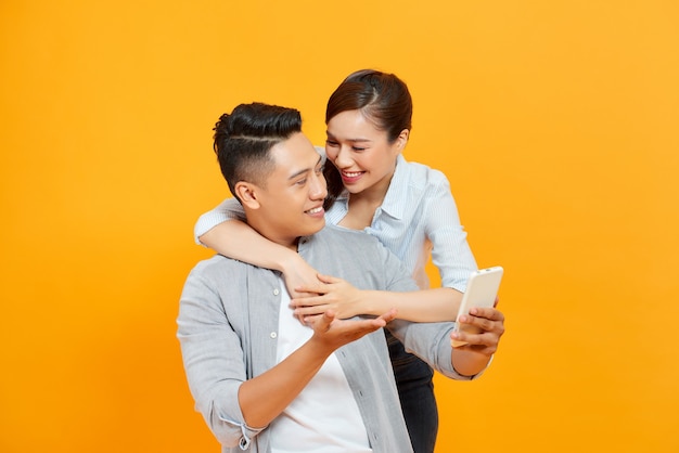 A couple isolated over a yellow color background