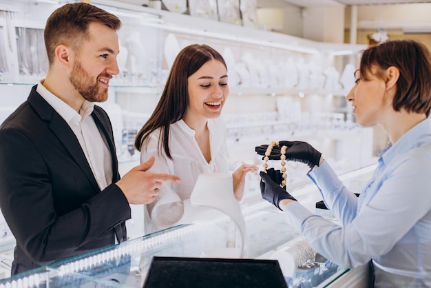 Couple at jewelry shop choosing a necklace together