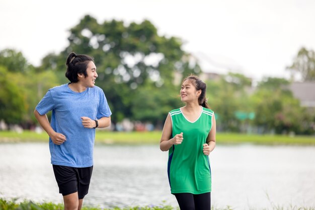 Couple jogging and running in natural environment on summer morning