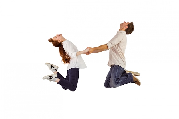 Couple jumping and holding hands