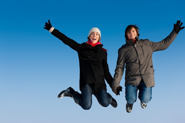 Couple jumping on a winter day