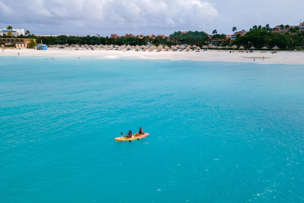 Couple kayaking in the ocean on vacation aruba caribbean sea