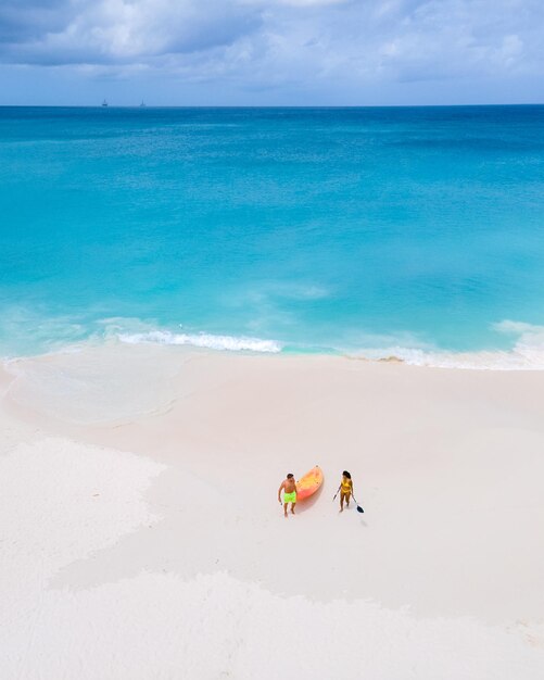 Couple kayaking in the ocean on vacation aruba caribbean sea