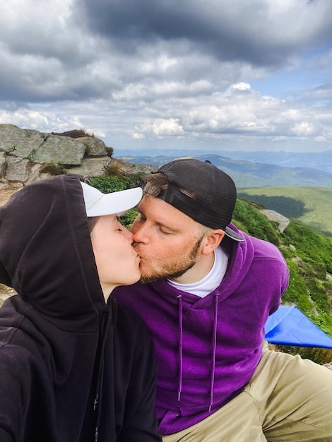 A couple kiss on the mountain