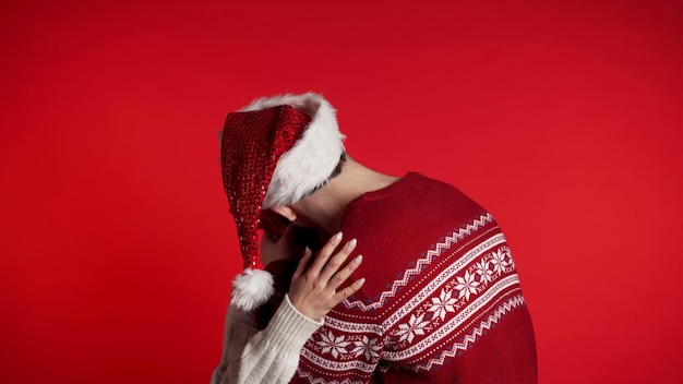 Couple kissing against red background