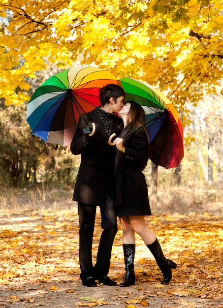 Couple kissing at alley in the park. 