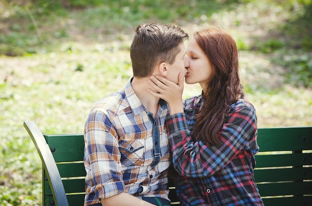 ベンチでキスするカップル