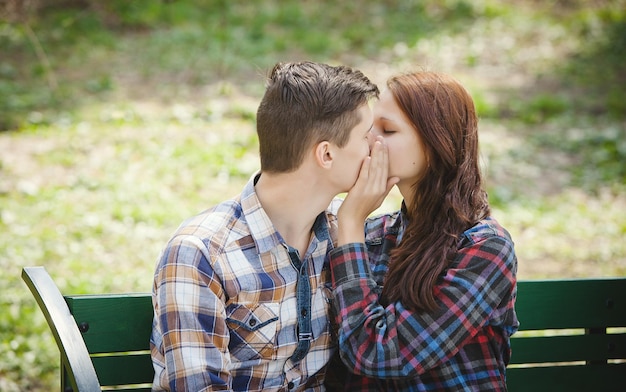 Couple kissing on the bench