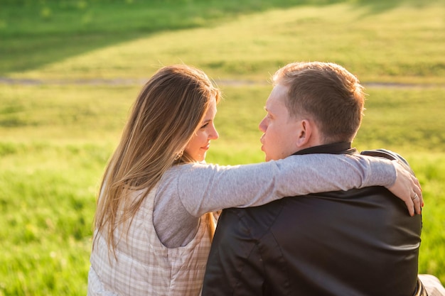 Couple kissing on field