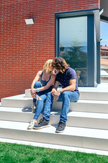 Couple kissing in front of their new house