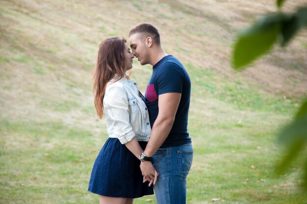 Couple kissing in a green field