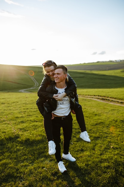 A couple kissing, hugging and loving each other at sunset