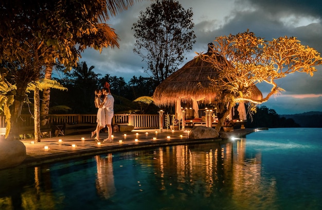 couple kissing at illuminated poolside during dusk