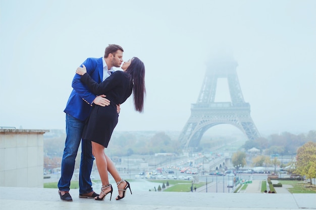 couple kissing near eiffel tower in paris valentines day destination in europe city of love