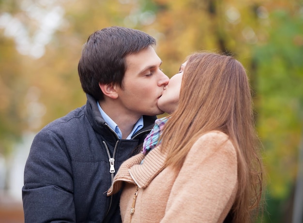 Couple kissing outdoor in the park