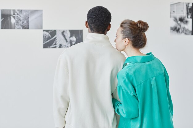 Couple Looking at Art in Museum Back View