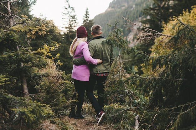 A couple looking at the forest in the mountains