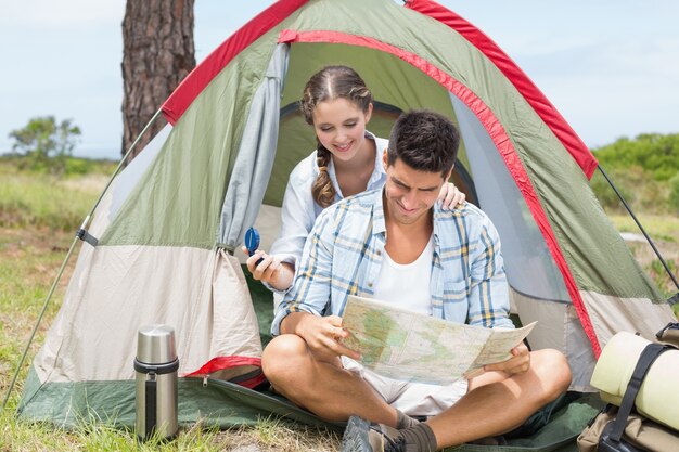 Sisters spending time in a tent on camping. Children using tablet playing games  online during summer vacation - a Royalty Free Stock Photo from Photocase