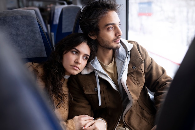 Photo couple looking outside through the window while traveling by train