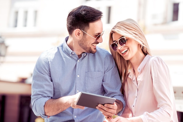 Couple looking at photos on tablet