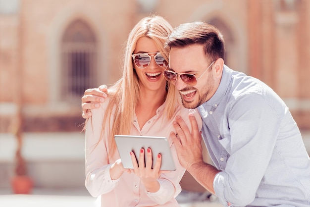 Couple looking at photos on tablet