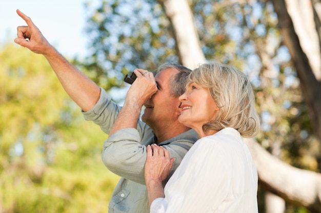 Couple looking at the sky with their binoculars